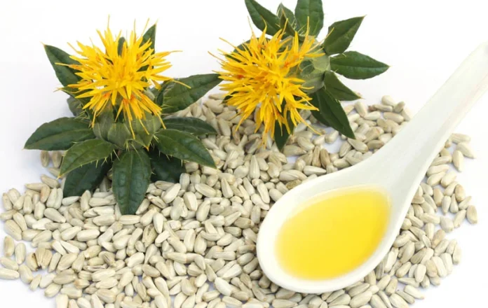 زيت العصفر الطبيعي المستخرج من بذور القرطم مع الزهور الصفراء.
